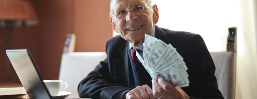 An elderly man holding money